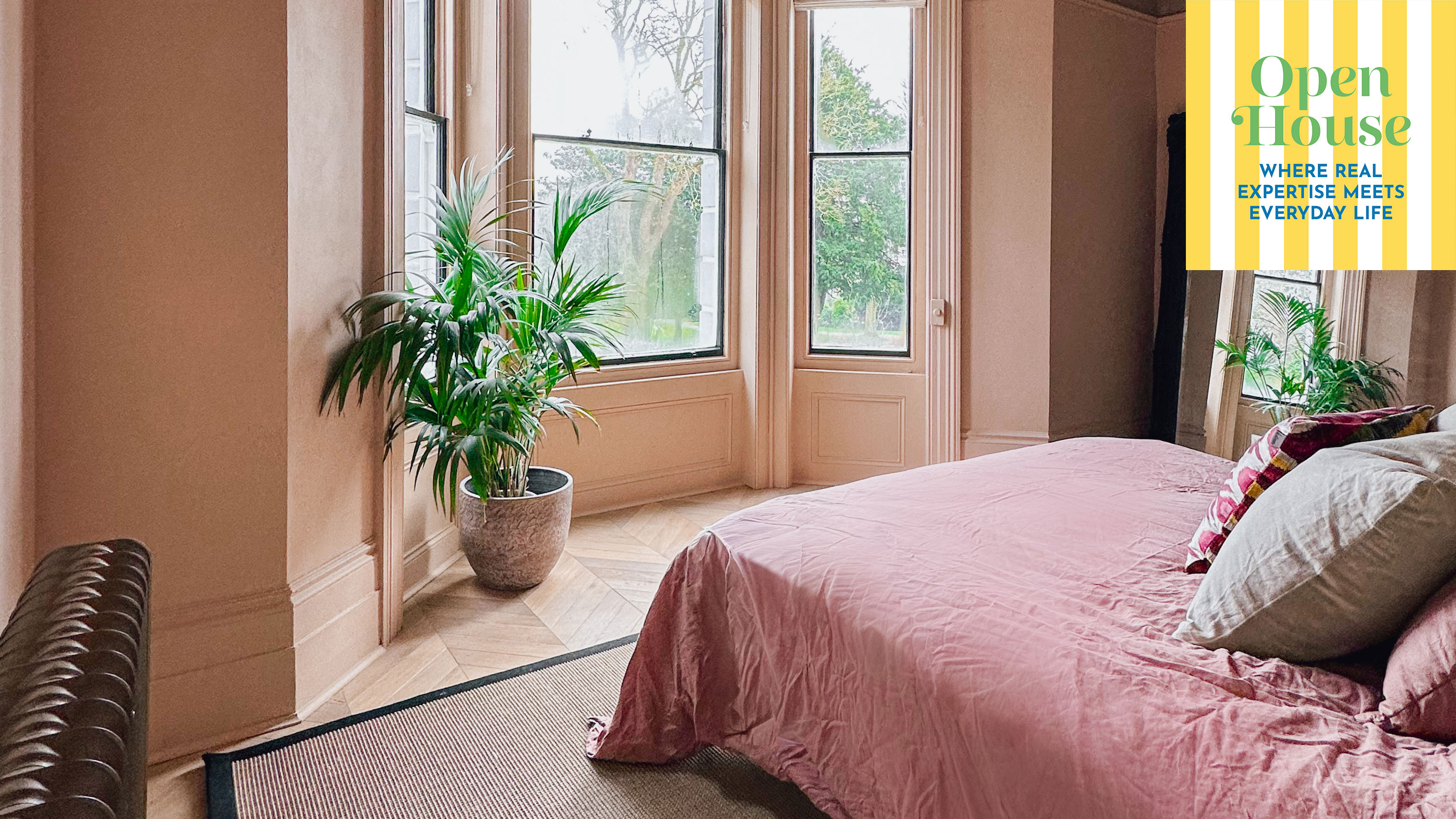 bedroom with beige walls and pink bed linen