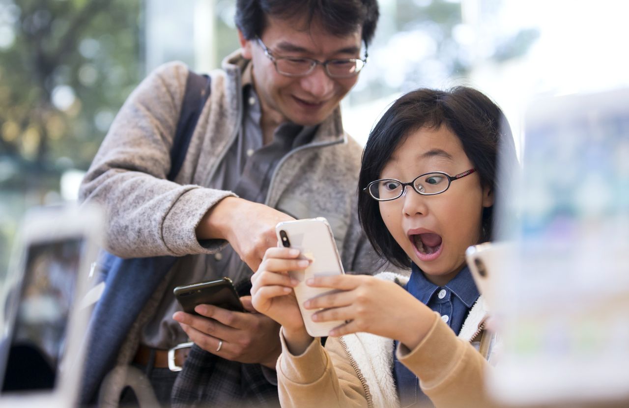 A woman tries the iPhone X.