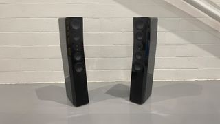 SVS Ultra Evolution Tower floorstanding speakers on grey floor in front of white brick wall