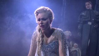 Samantha Barks as Elsa looking hurt as Hans stands behind her in Frozen: The Hit Broadway Musical