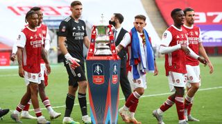 2019/2020 FA Cup champions Arsenal pass the trophy ahead of last year's FA Cup final