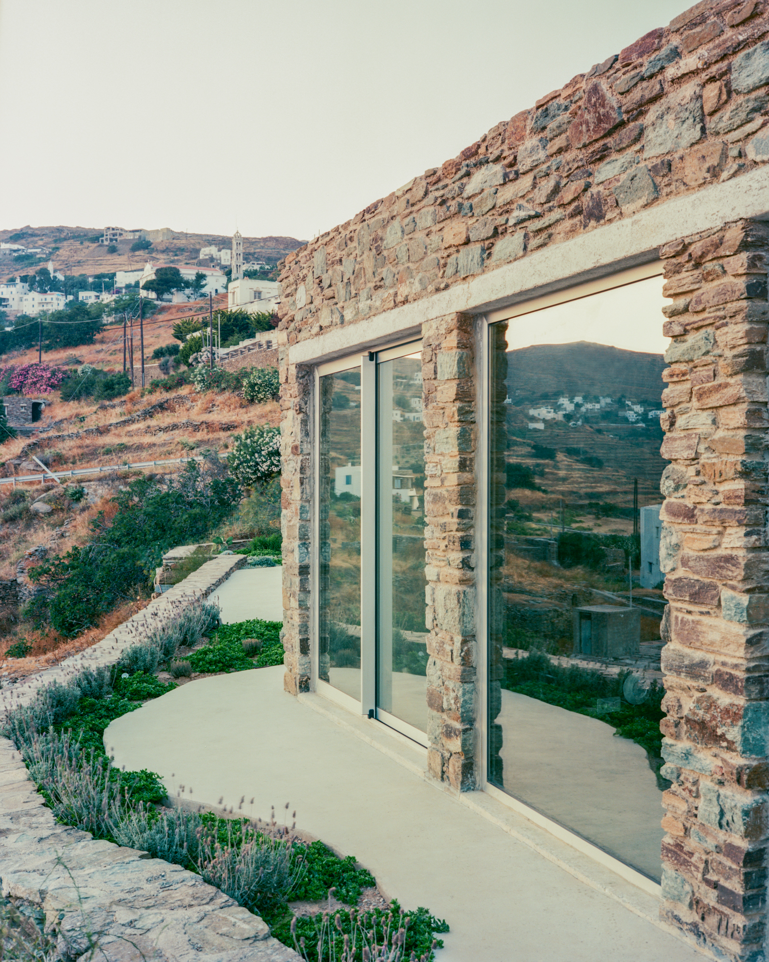 view of a Tinos house, using local vernacular such as stone walls and contemporary design