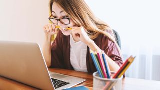 Student stressing out while looking at laptop