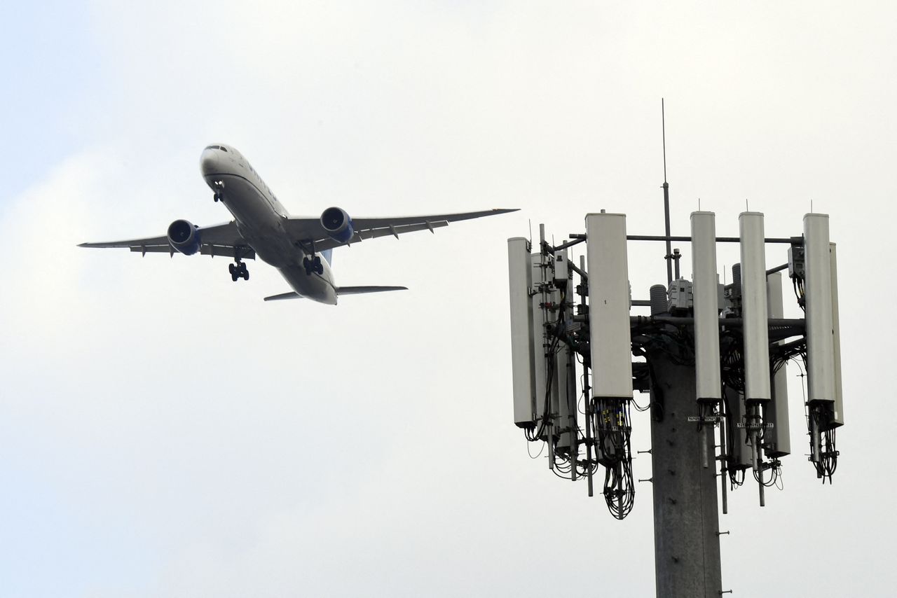 A cell tower is seen as a plane lands at Los Angeles International Airport. 