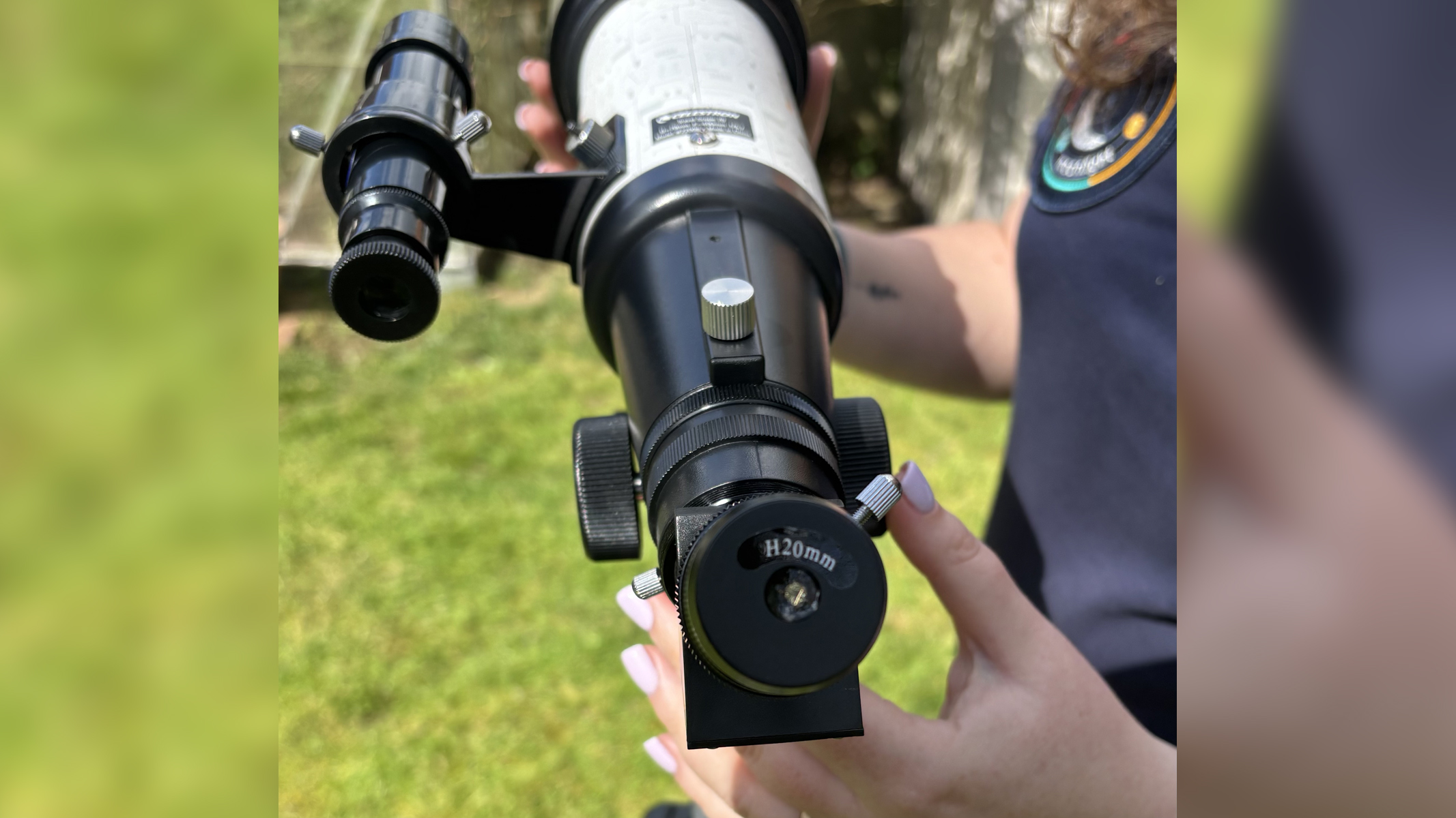 Author Gemma Lavender with a Celestron Moon Mission Travel Scope 70, an eyepiece on view of the scope.