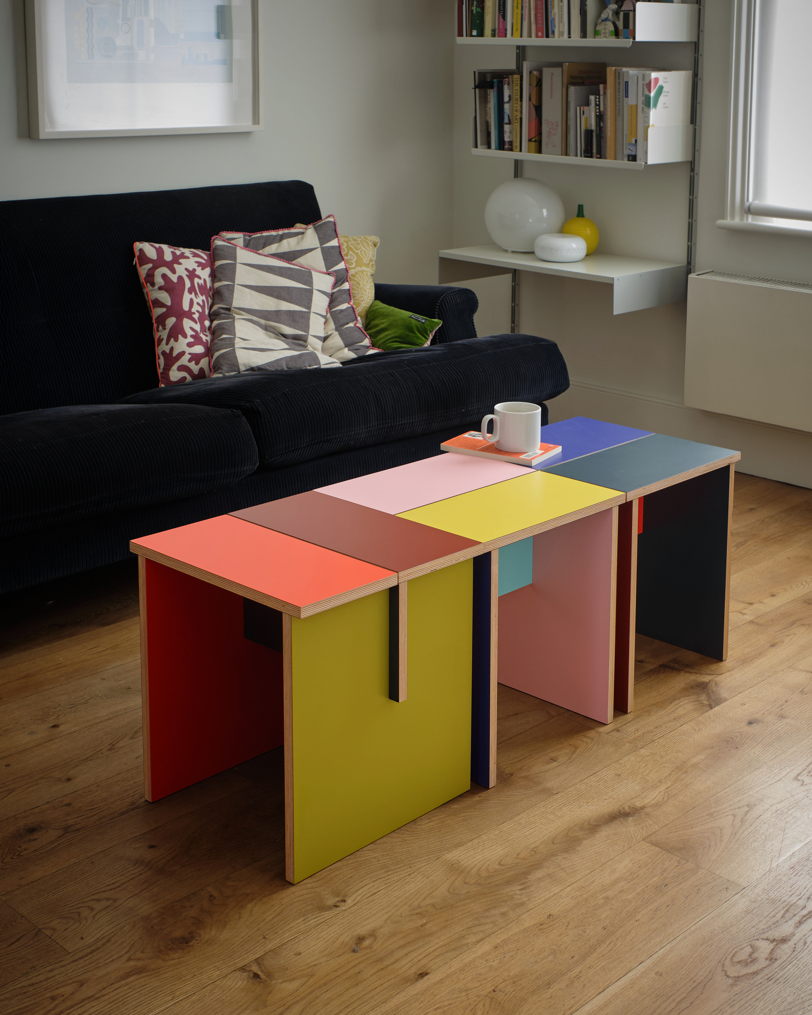 Tables made of colourful plywood sections intersected, made by Sophie Smallhorn for Uncommon projects