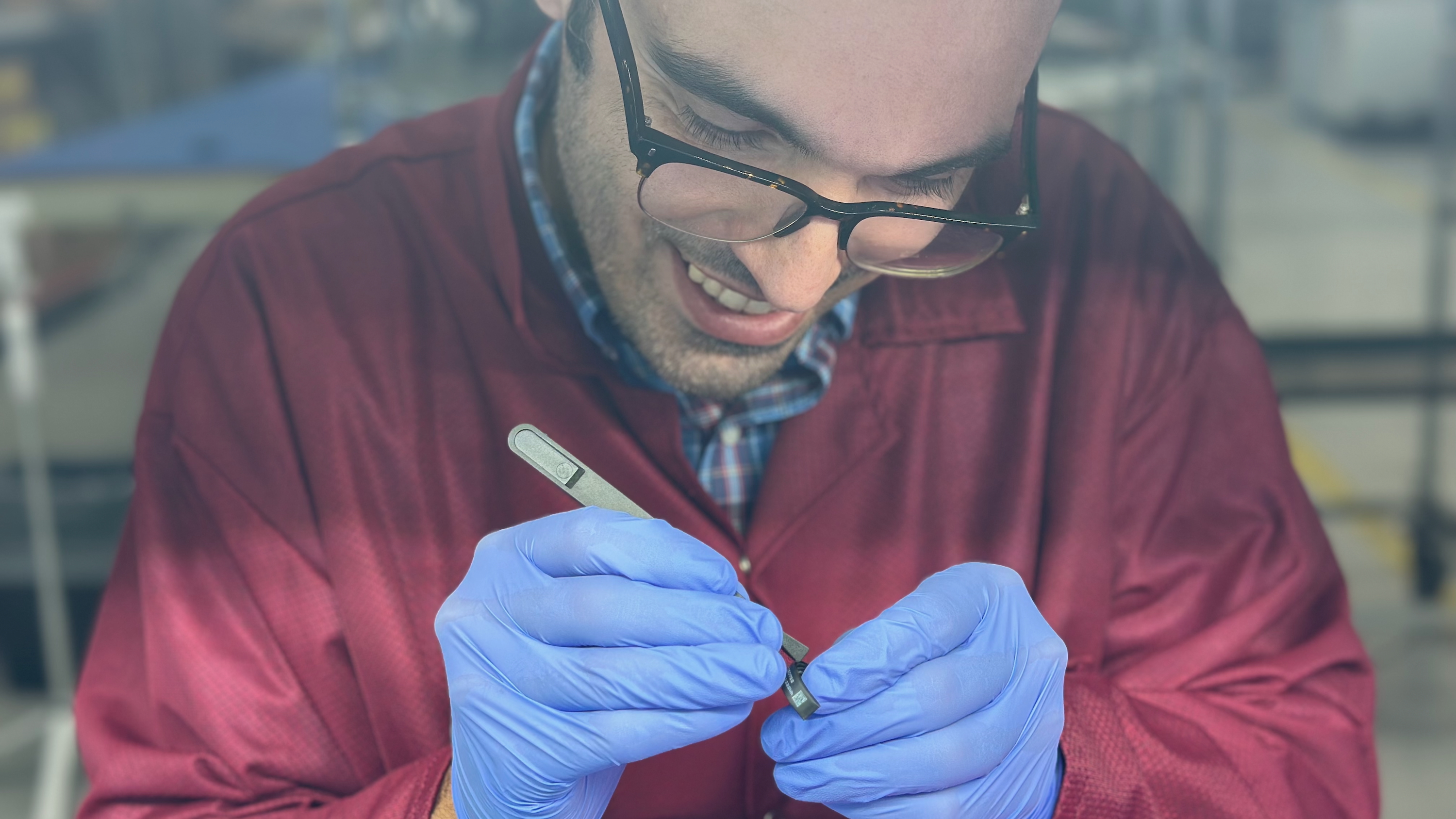 The author removing an adhesive cover from the Ultrahuman Ring Air body to attach the PCB onto it.