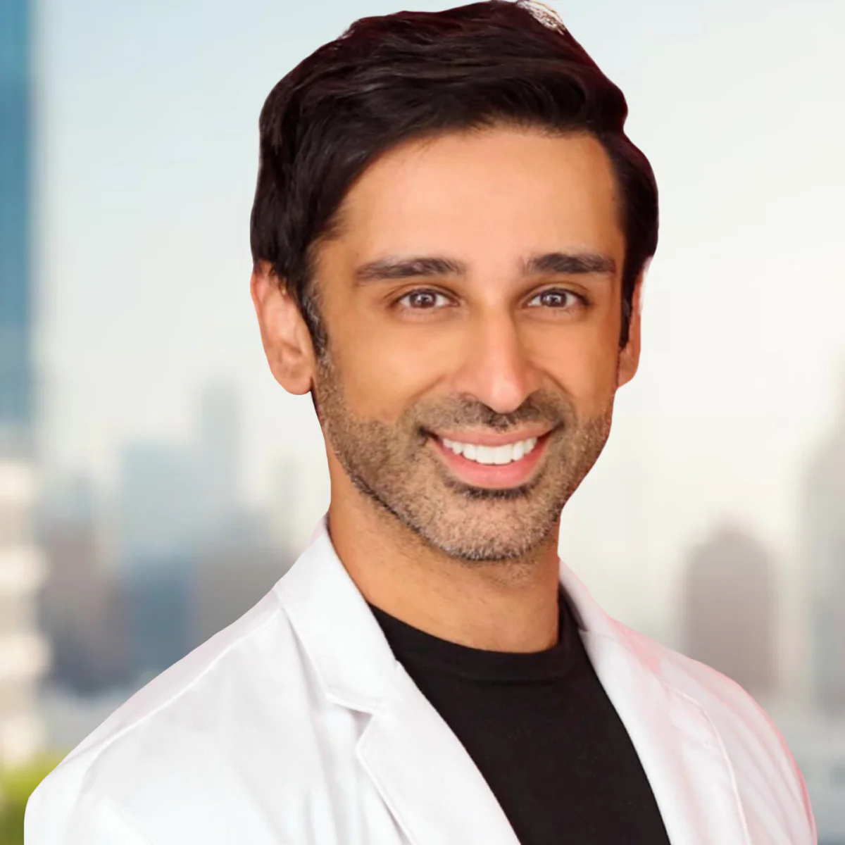 a brown man with short black hair in a white lab coat