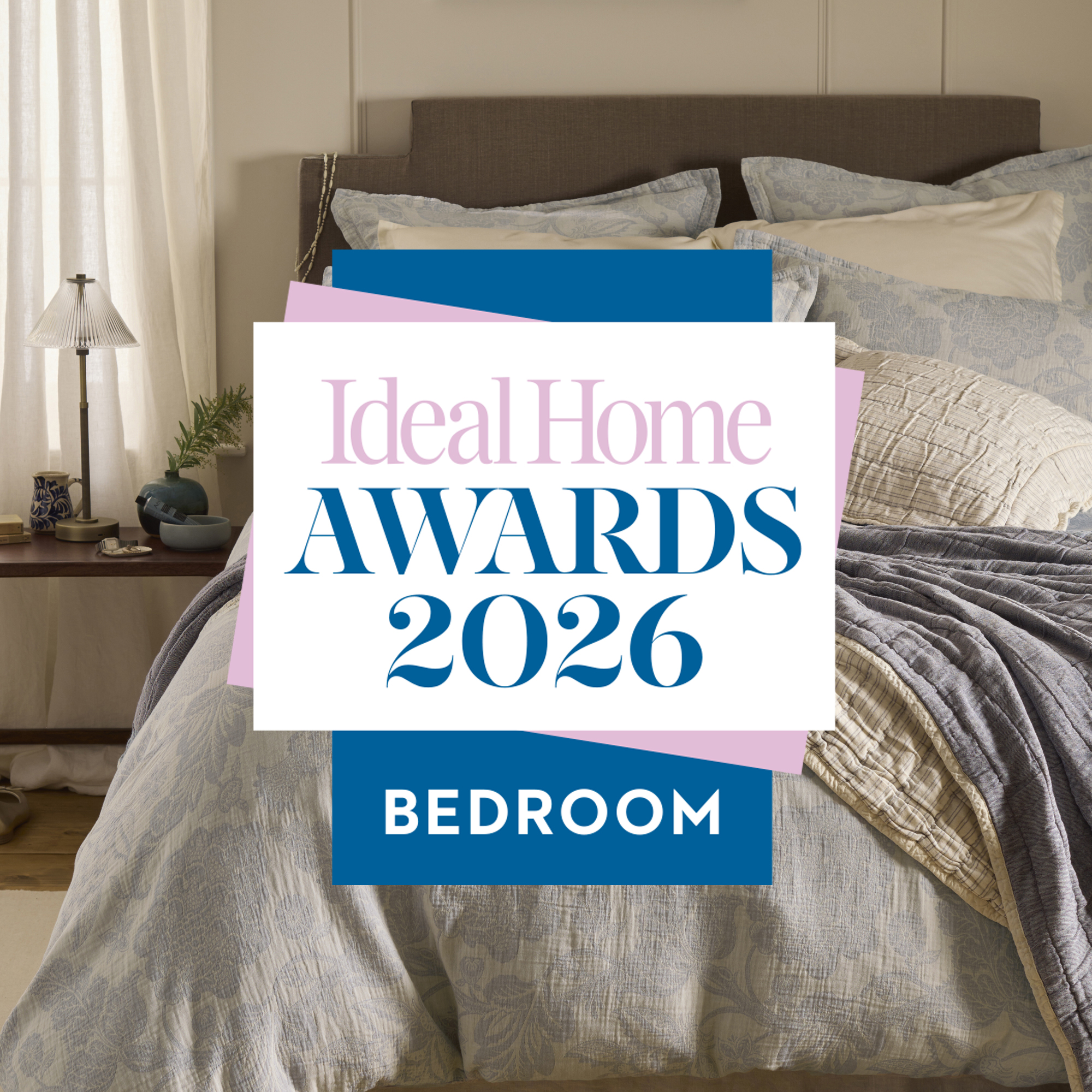 A bed with pale blue bedding and a graphic reading Ideal Home Bedroom Awards 2026