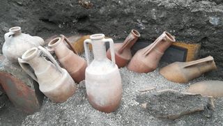 Archaeologists found amphorae, which look just like the ones in the painting, in front of the eatery.