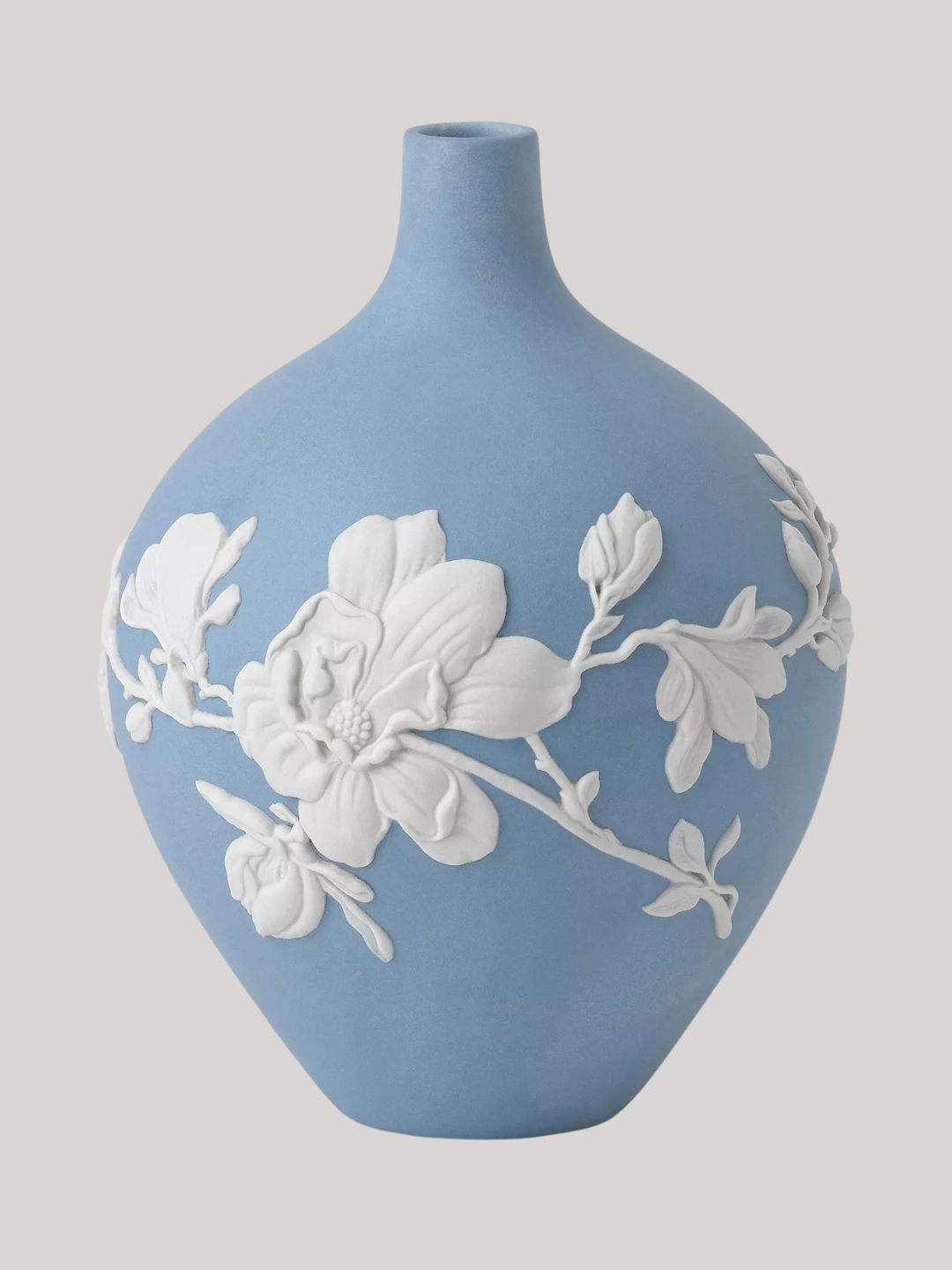 A pale blue vase with embossed white flowers
