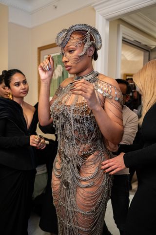 Megan Thee Stallion gets ready for the Gaurav Gupta haute couture show in Paris wearing a chainmail bodysuit and headpiece