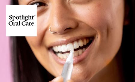 Woman using Spotlight oral care product