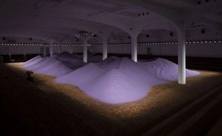 Prada’ s brown carpeted runway featured purple sand dunes at the Via Fogazzaro location