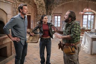 A father and daughter (Scott Foley as Eric and Maia Reficco as Olivia) speak with a contractor (Simone Luglio as Nino) inside an Italian villa, in La Dolce Villa.