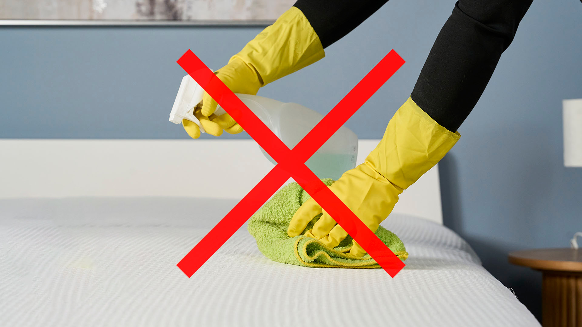 cleaning mattress with rubber gloves on