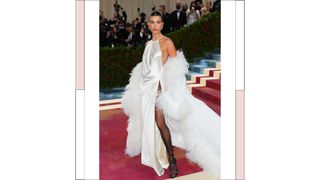 Hailey Baldwin Bieber wearing a white silk dress with a leg slit as she attends The 2022 Met Gala Celebrating "In America: An Anthology of Fashion" at The Metropolitan Museum of Art on May 2, 2022 in New York City