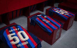 Barcelona shirts in the Camp Nou dressing room with 'DRAKE 50' on the back