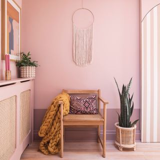Pink bedroom with radiator cover and wooden chair