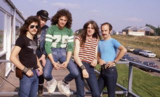 Soaking up the sun backstage at Donington in 1980: (l-r) Graham Oliver, Paul Quinn, Pete Gill, Biff Byford, Steve Dawson