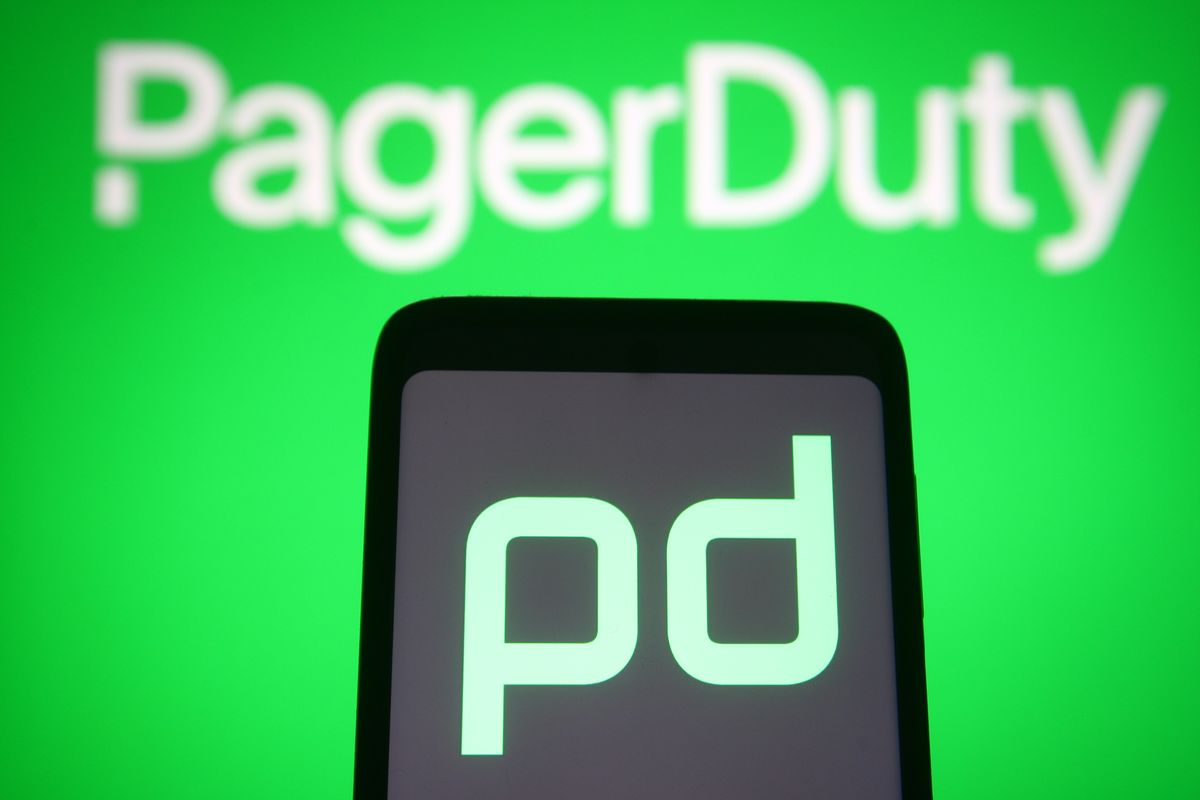 PagerDuty logo displayed on a green background with smartphone initials in foreground