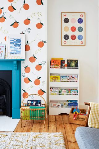Kids bedroom with orange wallpaper and blue fireplace
