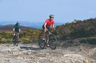 Rachel Sokal climbs on her gravel bike