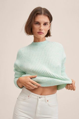 Woman wearing mint green cropped sweater from Mango's sale collection