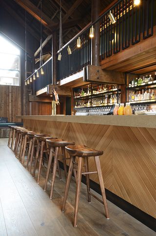 bar area with wooden stools