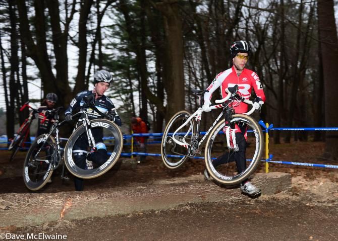 Justin Lindine (Redline) leading Nick Keough across barriers made from logs.