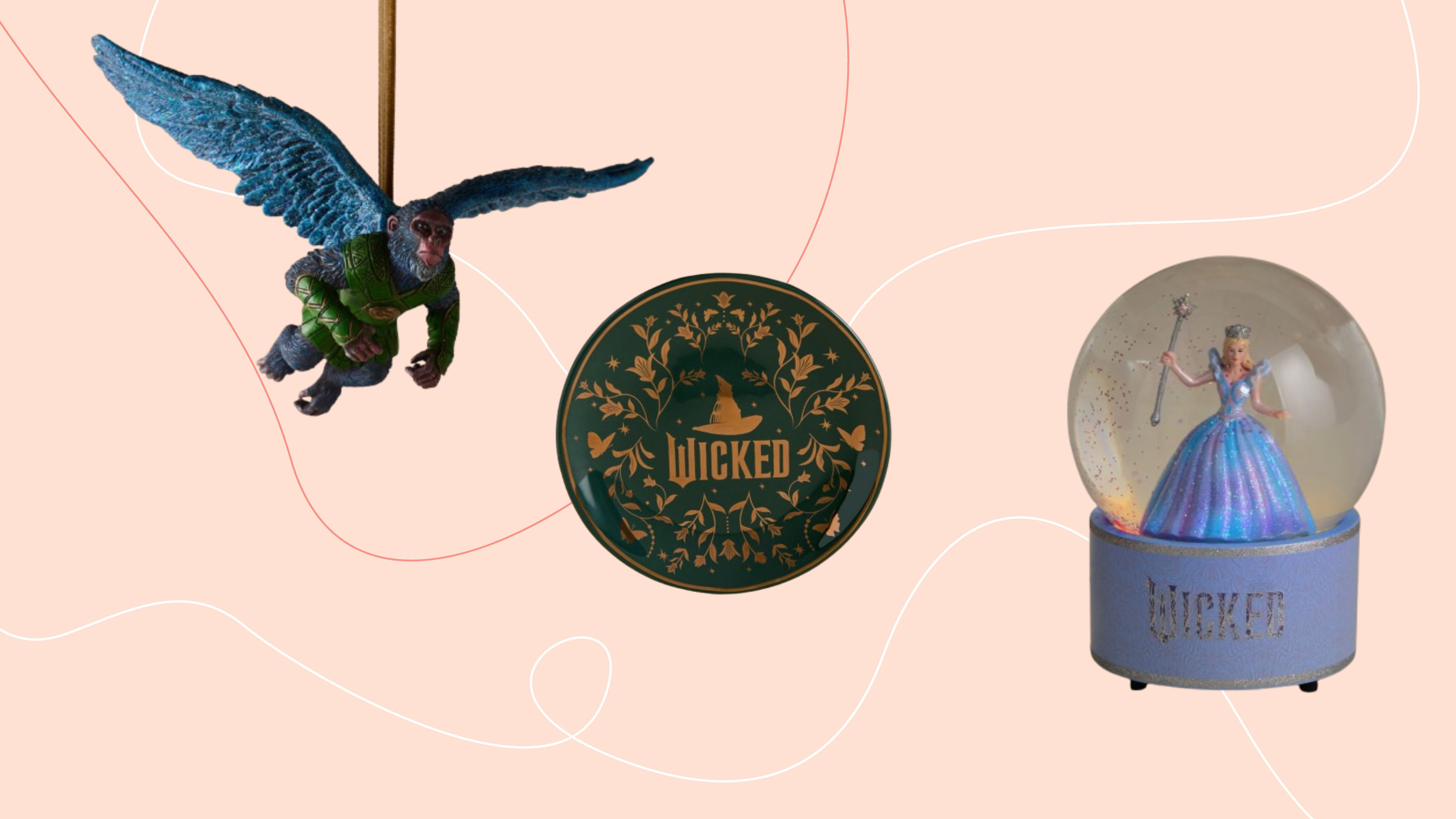 Wicked flying monkey, trinket dish and snow globe on a pink background