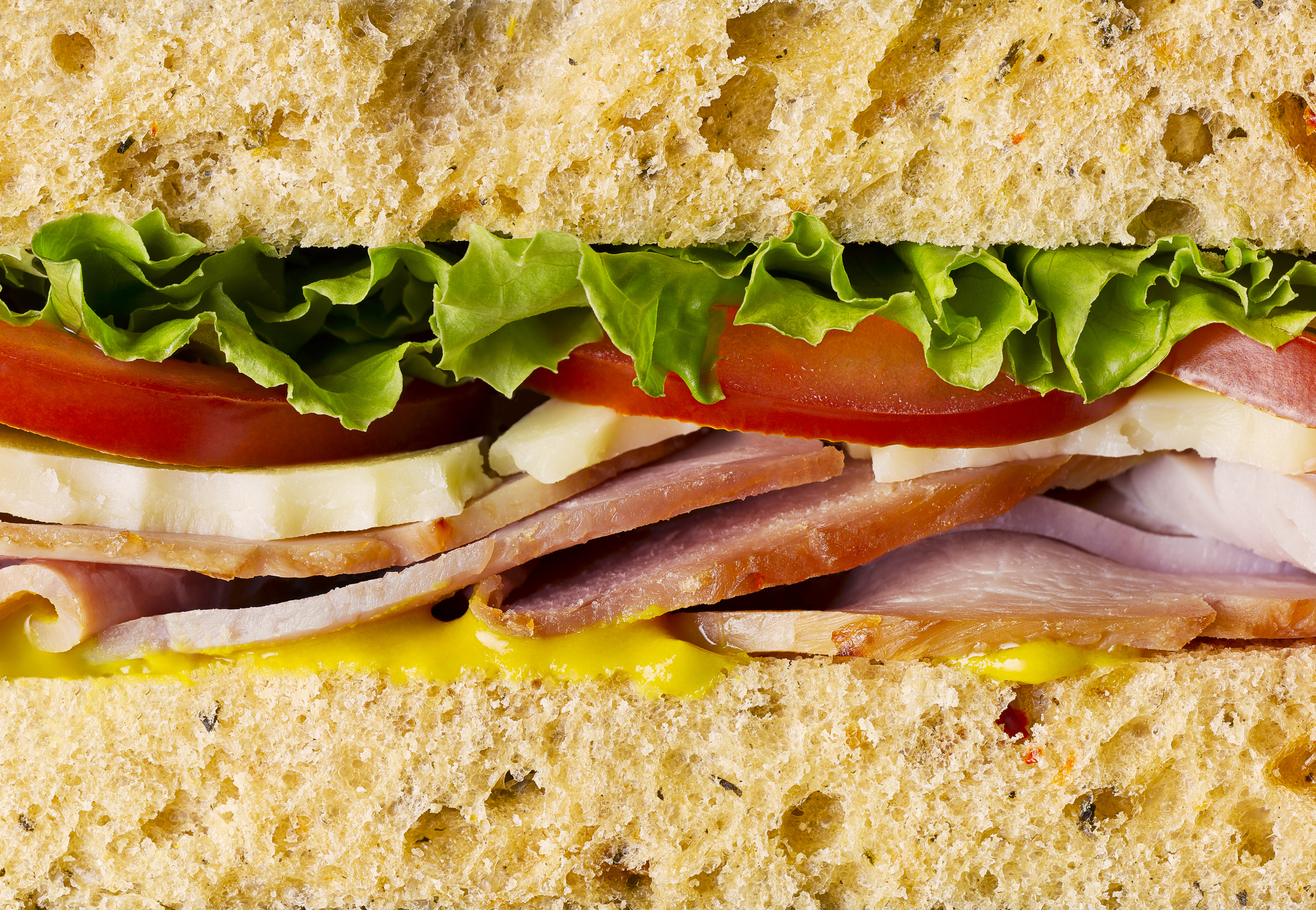 A close-up of a ham sandwich.