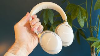 Bose QuietComfort Ultra Headphones held in a man's hand