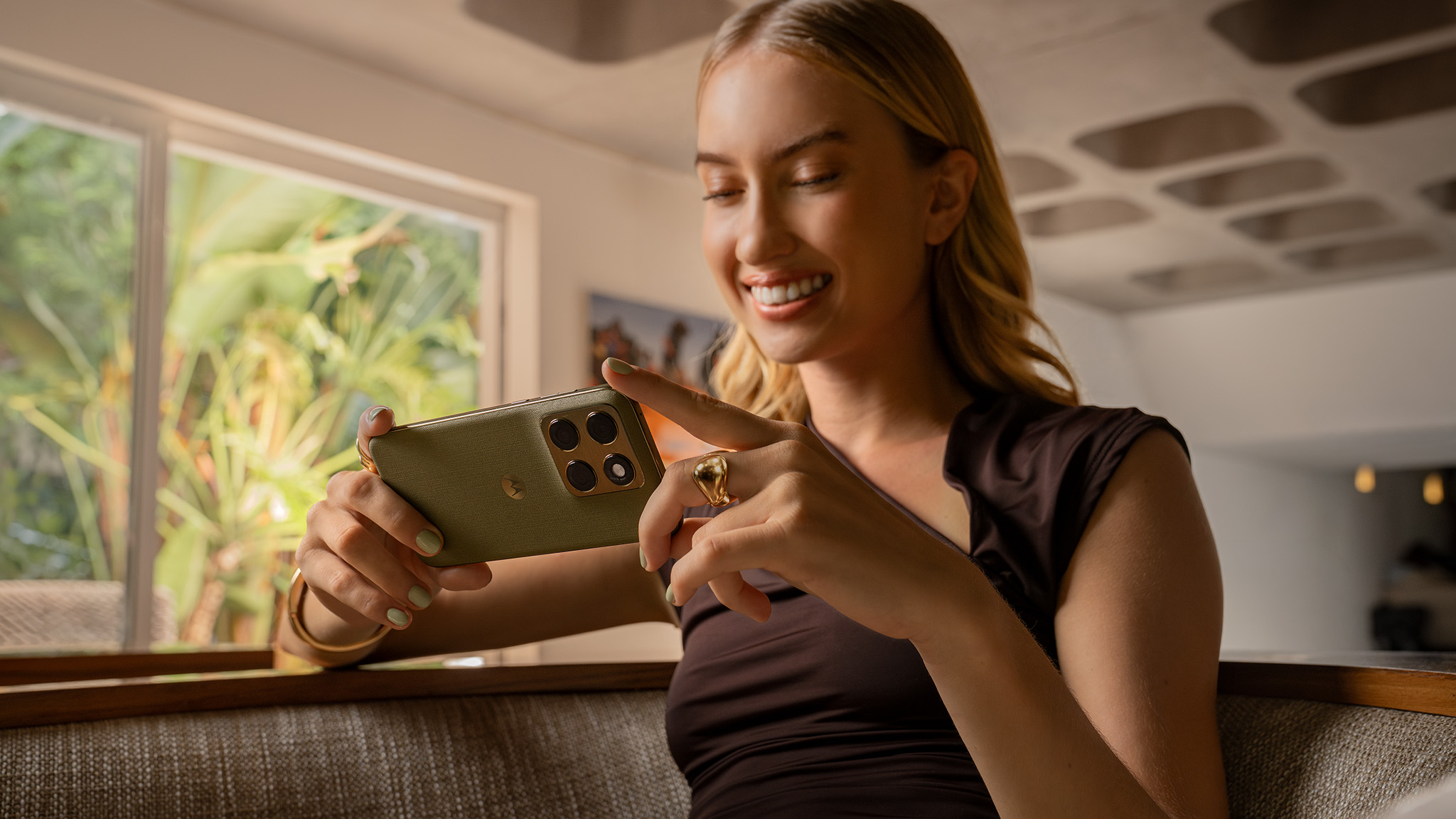 An official lifestyle image of someone holding the green Motorola Edge 2026