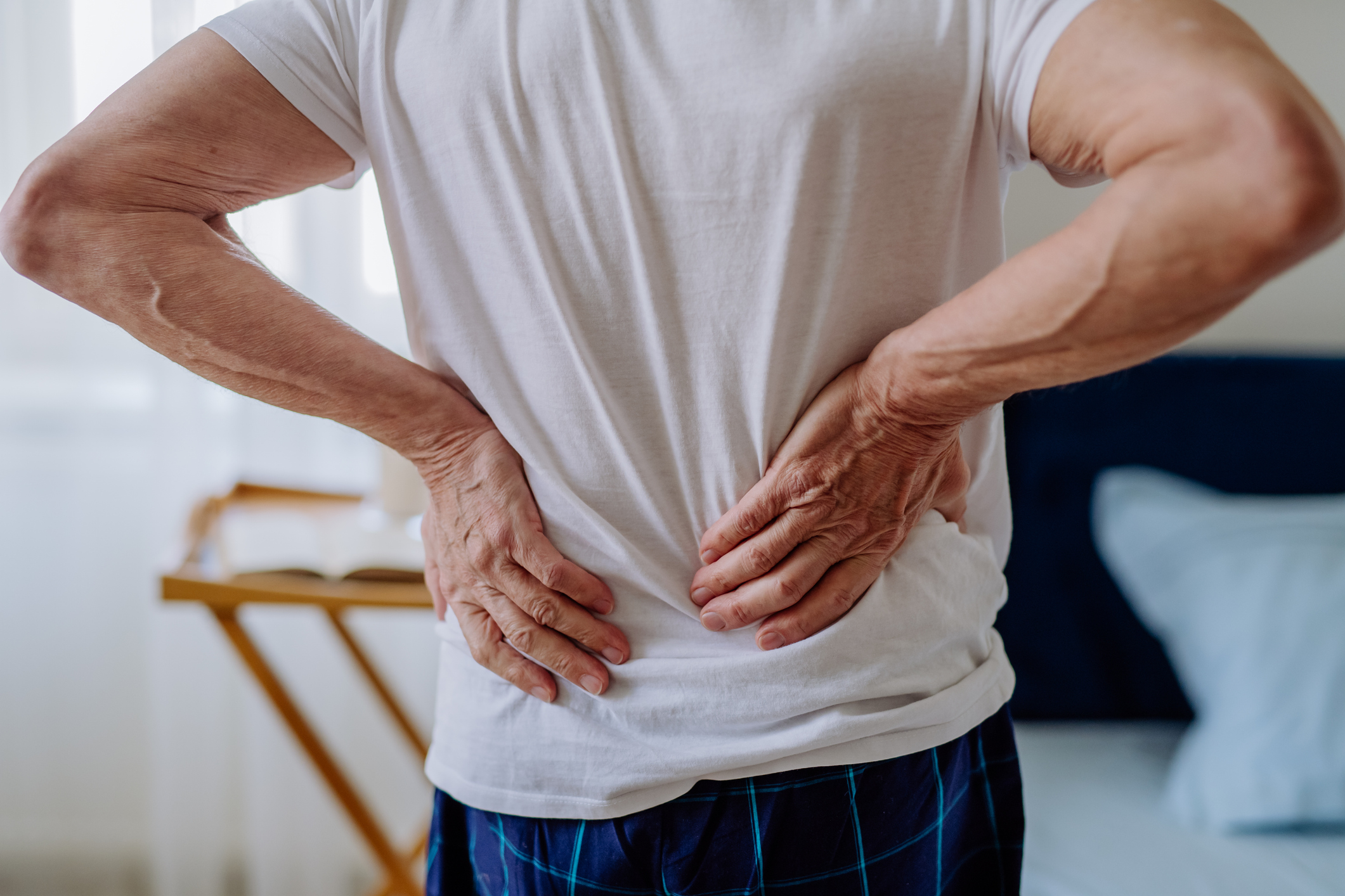 Older man holding his back