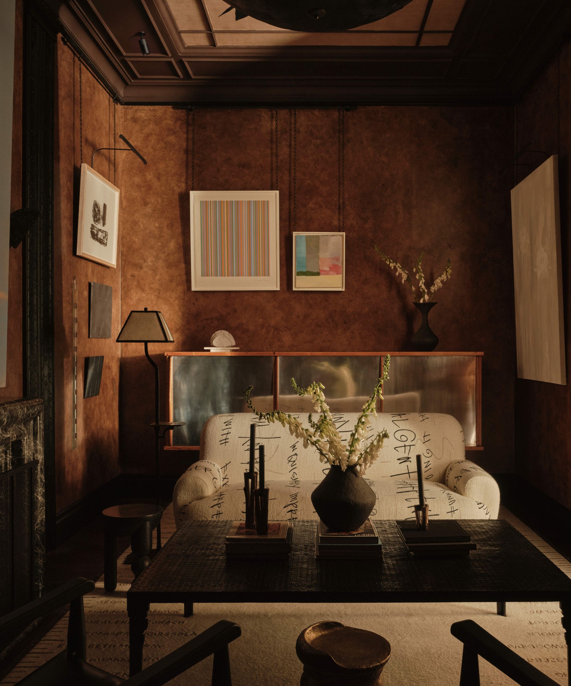 Moody living room with textured brown walls and a mix of old and new furniture