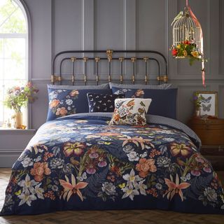bedroom with bed cushions and botanical duvet set