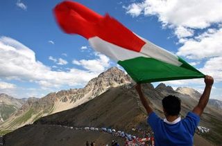 An Italian flag flies over the peloton