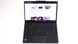 An open and powered on black laptop against a white background.