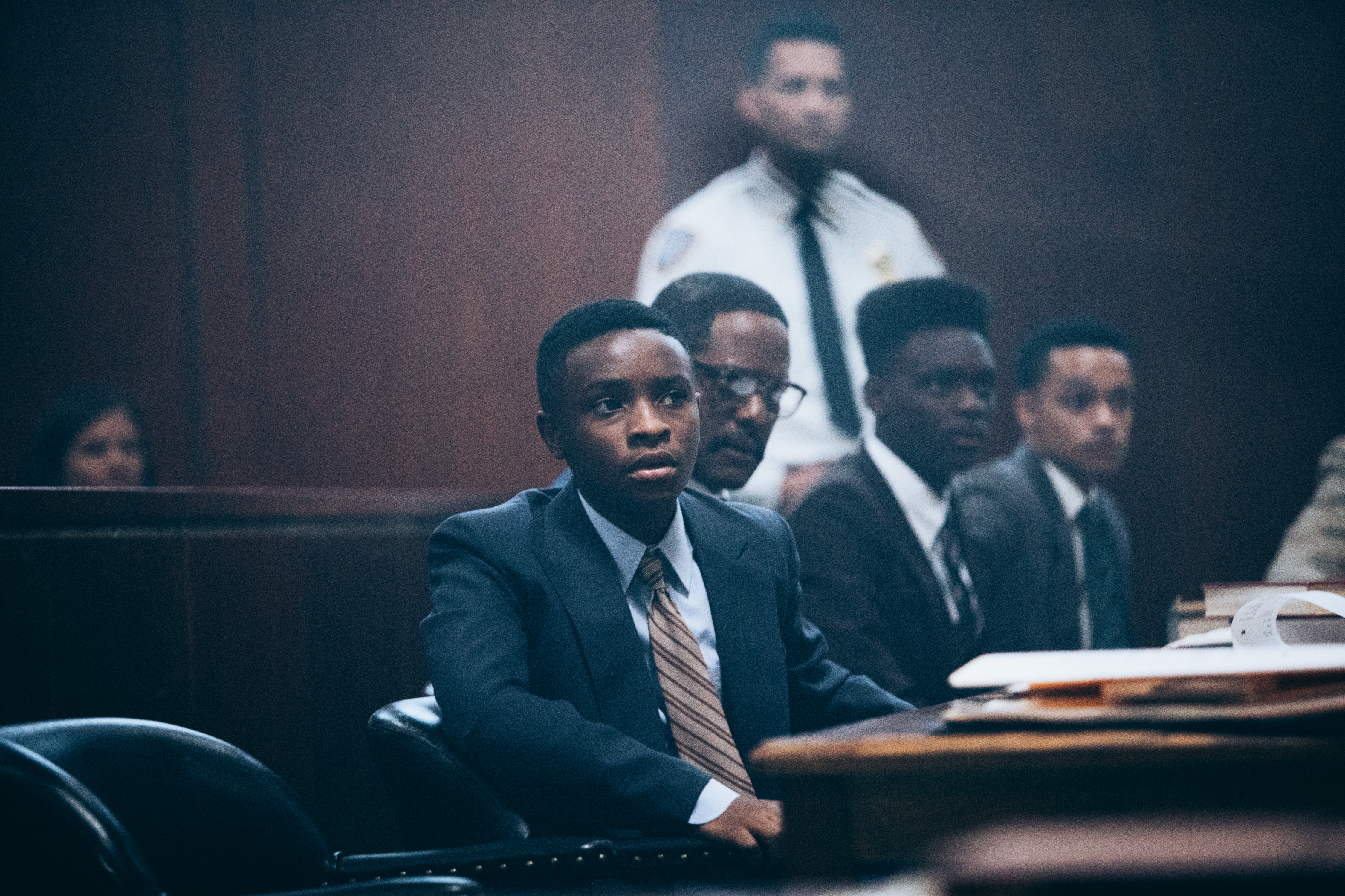 Four young Black boys sit at the defendants' table in a court room, in 'When They See Us.'