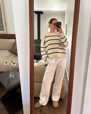 @livvperez wearing white trousers, striped jumper and Birkenstocks