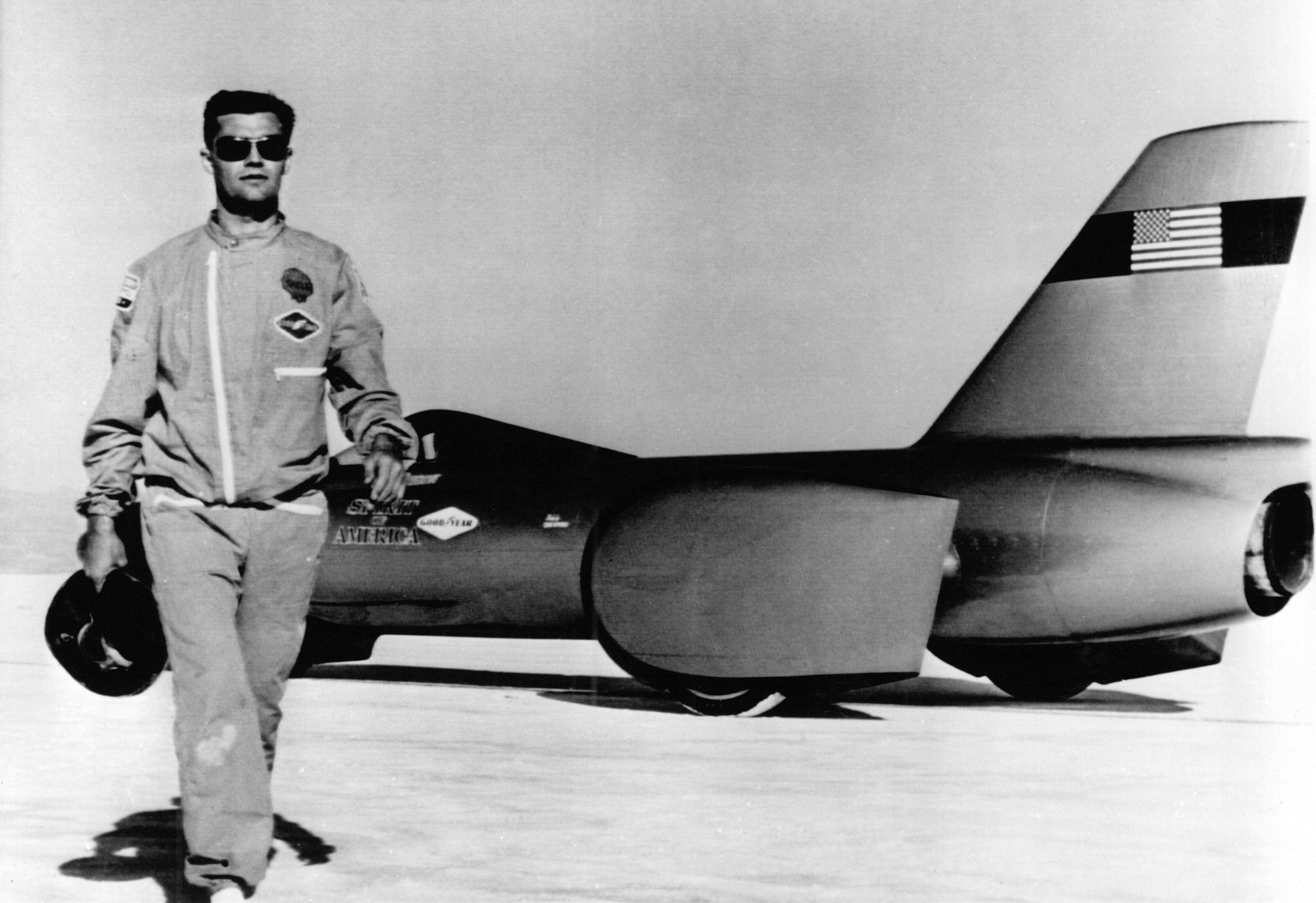Craig Breedlove stands in front of Spirit of America, after breaking the world land speed record in 1963