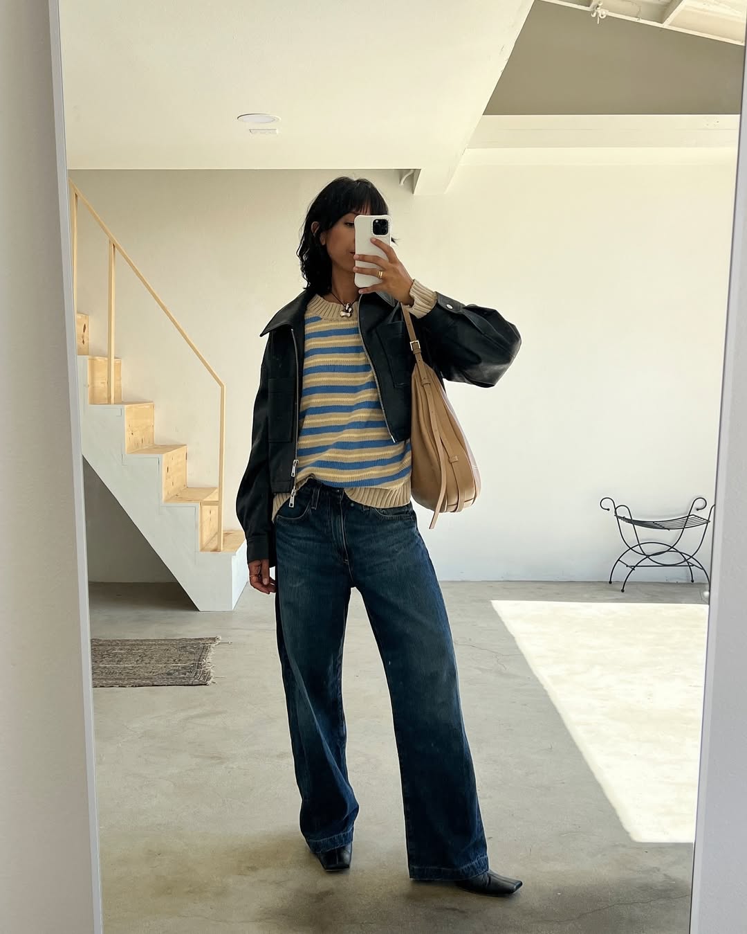 woman wearing dirty denim wash jeans fall denim trend 2025