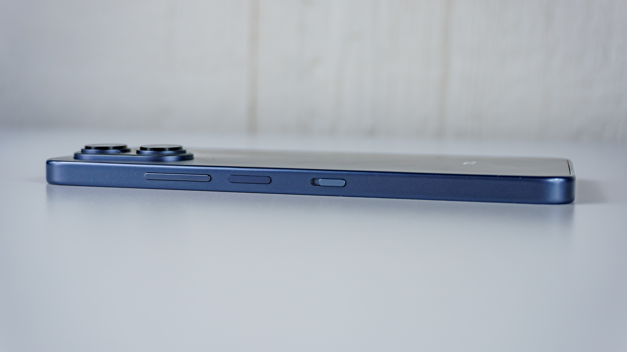 The TCL NXTPAPER 70 Pro on its side showing off its buttons and NXTPAPER Key