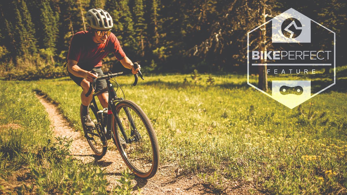 A gravel rider rides a single track gravel climb on a bike equipped with the new RockShox XPLR Rudy suspension fork