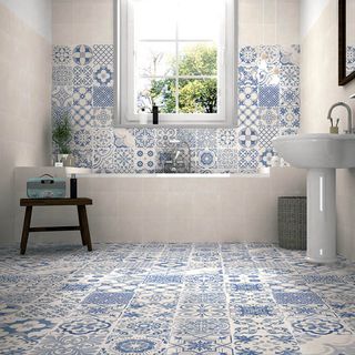 bathroom with blue and white floor tiles with white basin