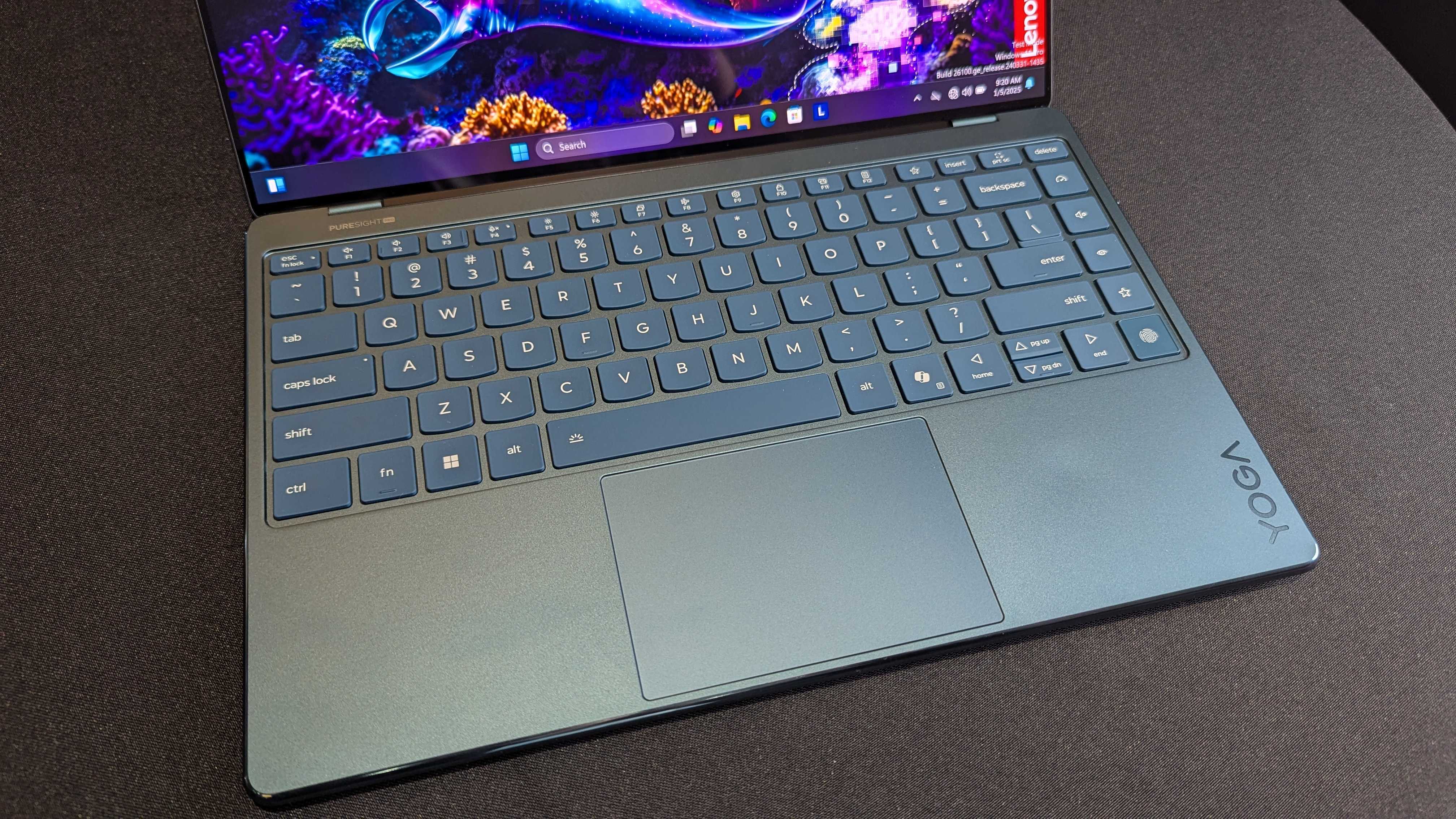 A close-up of the Lenovo Yoga Slim 9i 14 (Gen 10)'s keyboard, including the additional macro keys and built-in fingerprint sensor.