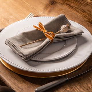 Napkins with ribbon and plates