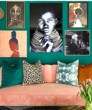colors that go with dark green, living room with dark green walls, artwork and pictures on wall, coral couch