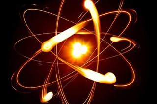 an atom with electrons swirling around it.